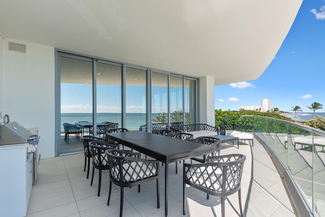 balcony featuring a water view and a grill