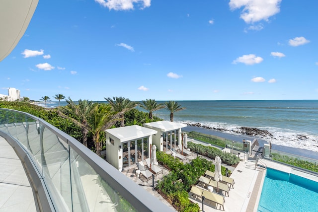 balcony with a beach view and a water view