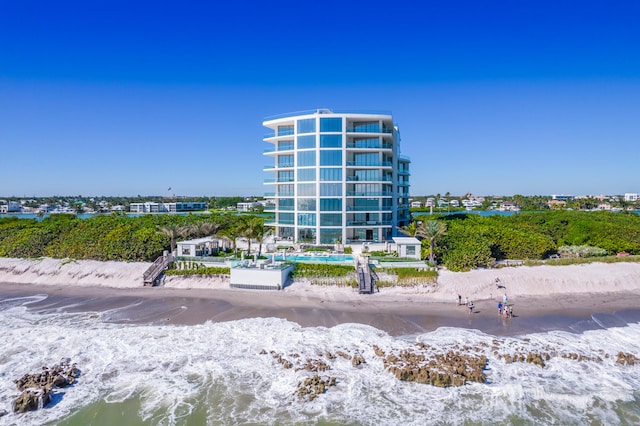 view of property featuring a view of the beach and a water view