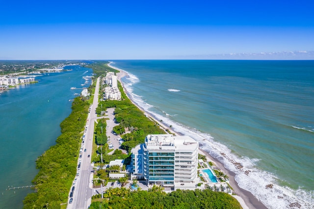 drone / aerial view featuring a beach view and a water view