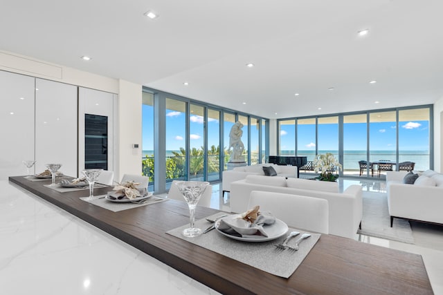 living room featuring expansive windows and a water view