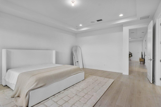 13450 Artisan Cir, Palm Beach Gardens, FL 33418 - bedroom featuring a raised ceiling, light wood finished floors, recessed lighting, and baseboards