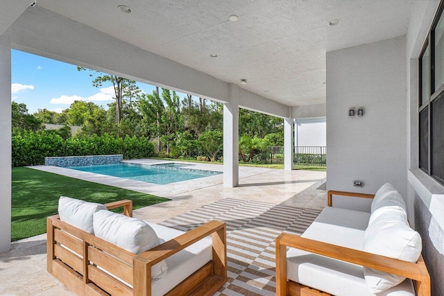 view of patio / terrace with fence, an outdoor living space, and an outdoor pool