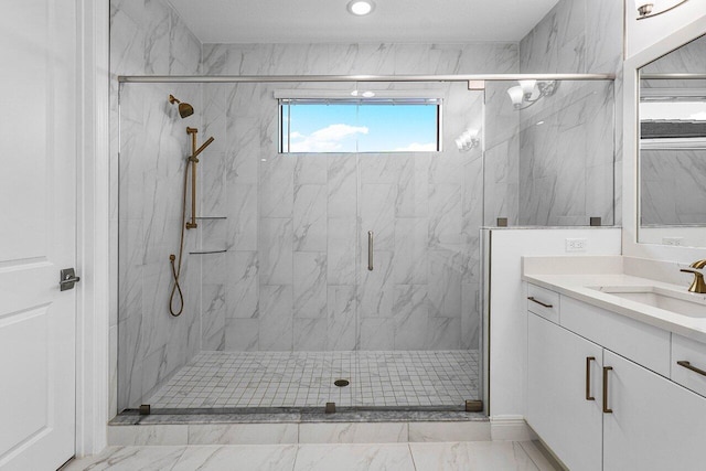 bathroom featuring marble finish floor, a marble finish shower, and vanity