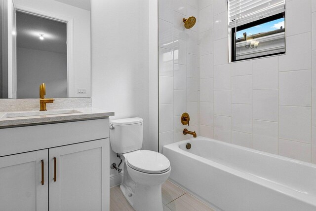 bathroom with toilet, vanity, and a shower with door