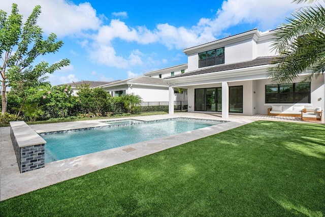 view of pool featuring a lawn and a patio