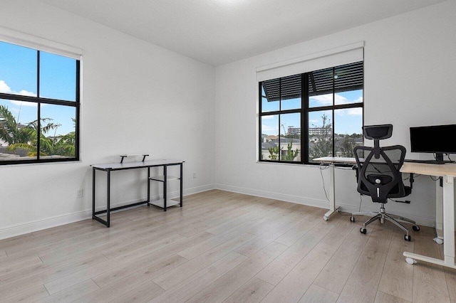 office area with baseboards and wood finished floors