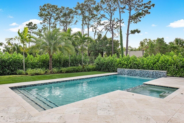 view of pool with a pool with connected hot tub