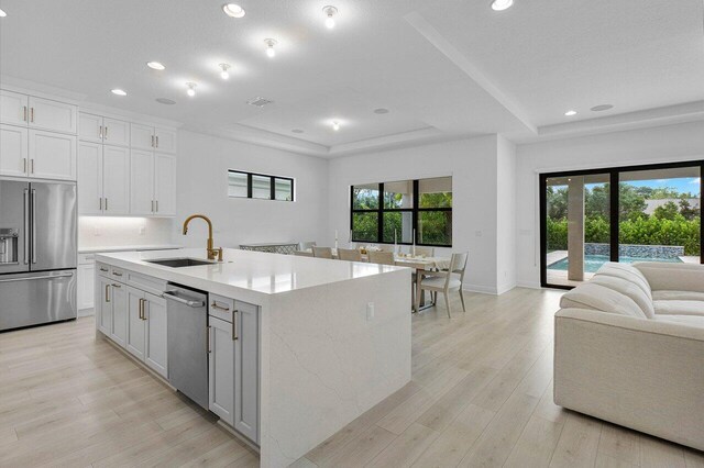 dining space with light hardwood / wood-style flooring and sink