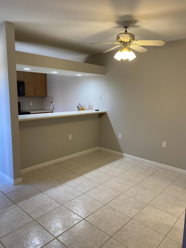 kitchen with decorative backsplash, ceiling fan, and light tile patterned flooring