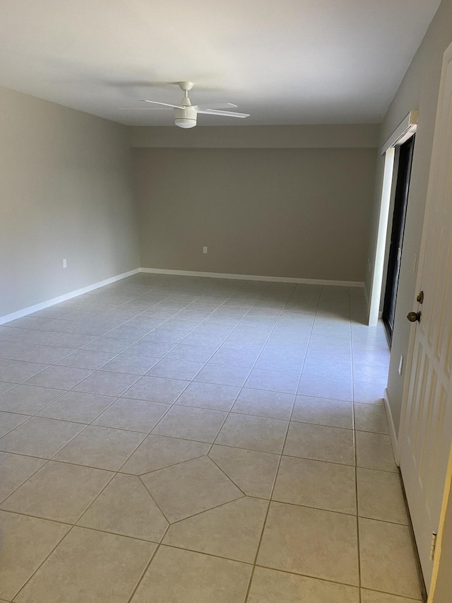 spare room featuring ceiling fan and light tile patterned floors