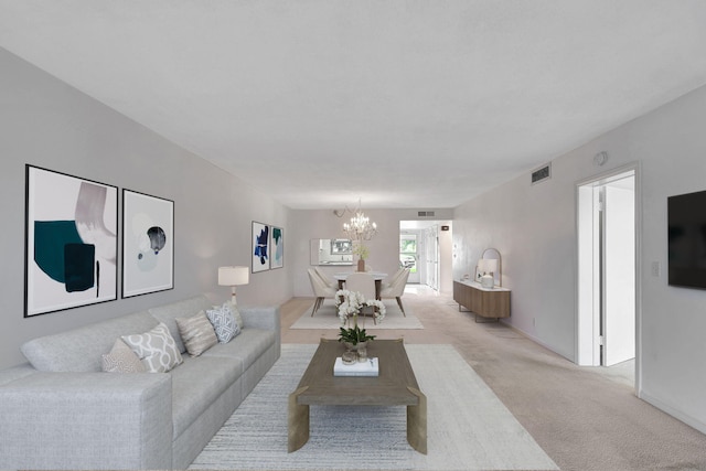 carpeted living room with a chandelier