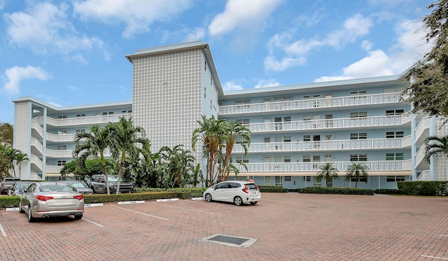 60 Yacht Club Dr Unit 106, North Palm Beach, FL 33408 - view of apartment building / complex featuring uncovered parking
