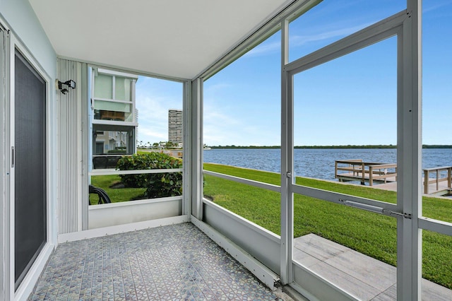 unfurnished sunroom featuring a water view