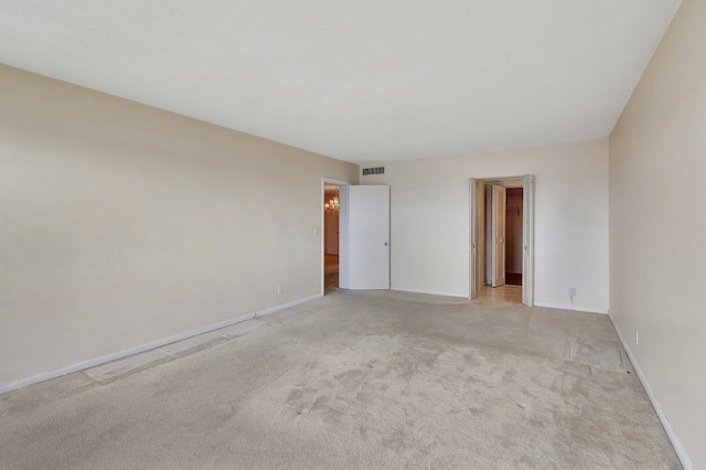 unfurnished room with light carpet