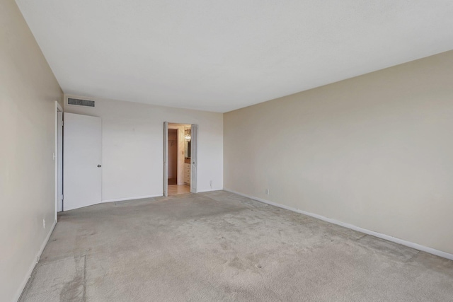 spare room featuring light colored carpet