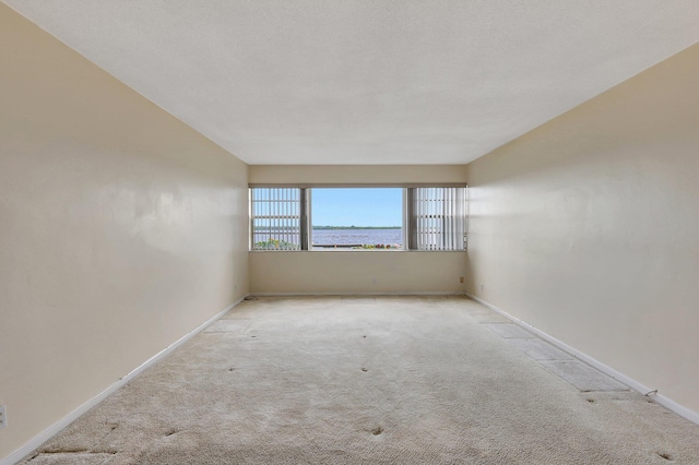 carpeted spare room featuring a textured ceiling