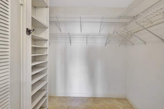 spacious closet featuring light tile patterned flooring