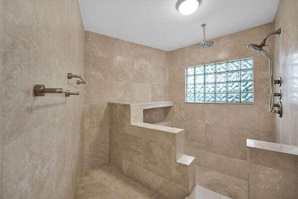 bathroom with a tile shower