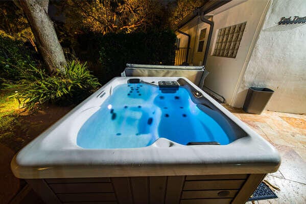 view of swimming pool with a hot tub