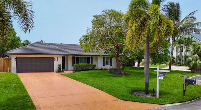 ranch-style home with a front lawn and a garage