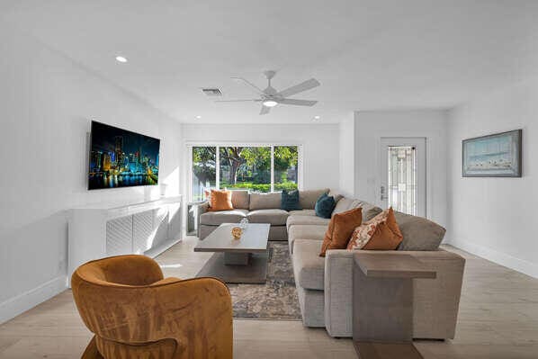 living room with ceiling fan and light hardwood / wood-style floors