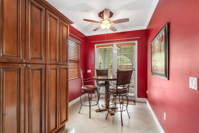 dining room featuring ceiling fan, light tile patterned floors, and crown molding