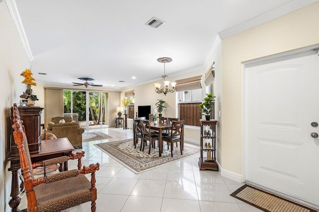 tiled dining area featuring ceiling fan with notable chandelier and crown molding