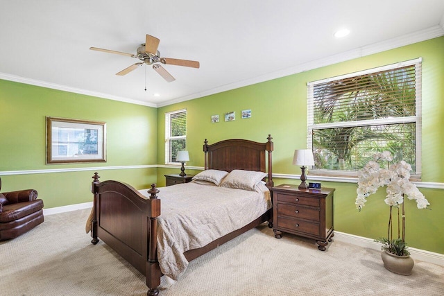 carpeted bedroom with multiple windows, ceiling fan, and crown molding