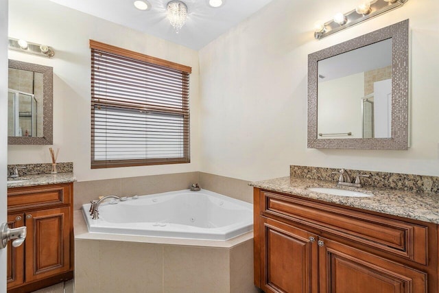 bathroom with vanity and independent shower and bath