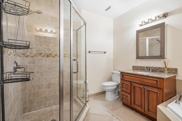 bathroom with vanity, tile patterned floors, toilet, and an enclosed shower