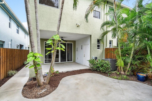 exterior space with central AC unit, a patio, and ceiling fan