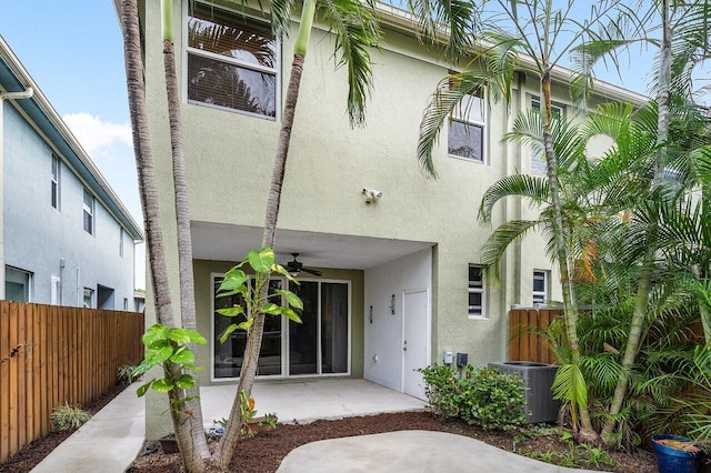 rear view of house with central air condition unit, a patio area, and ceiling fan