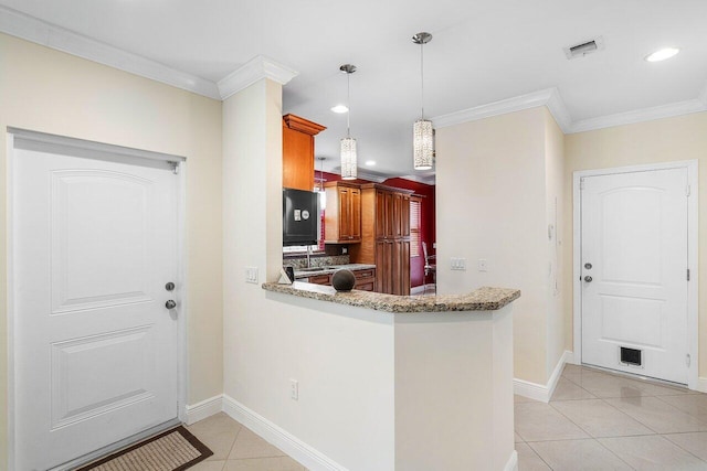 kitchen featuring crown molding, light tile patterned floors, pendant lighting, and kitchen peninsula