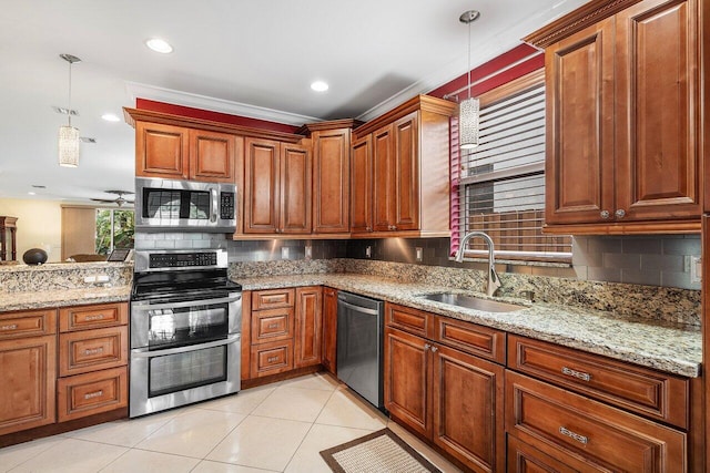 kitchen featuring backsplash, appliances with stainless steel finishes, decorative light fixtures, light tile patterned floors, and sink