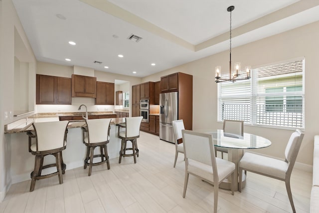 dining area featuring a notable chandelier