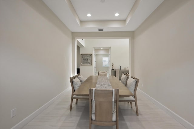 dining room featuring a raised ceiling