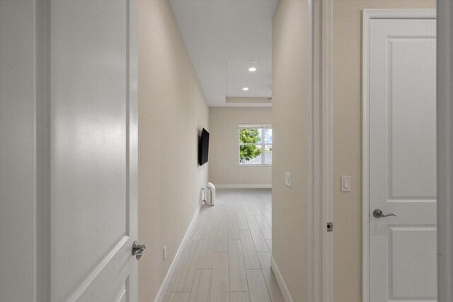 hallway with hardwood / wood-style floors