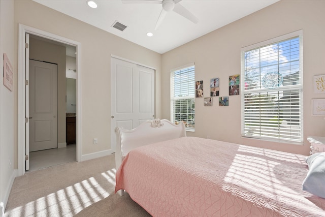 carpeted bedroom featuring ceiling fan and a closet