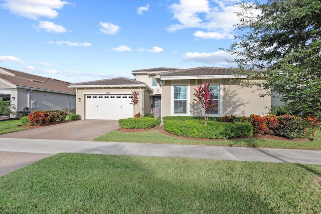 view of front of home with a garage and a front yard