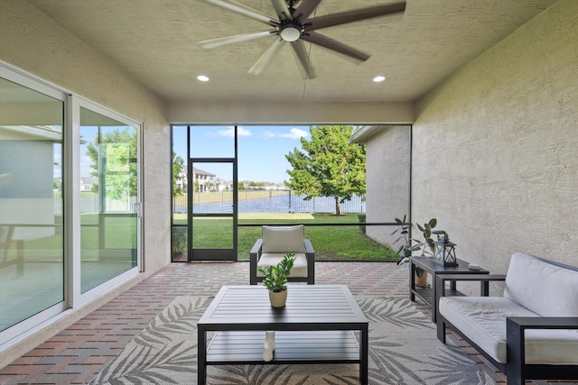 sunroom / solarium featuring ceiling fan