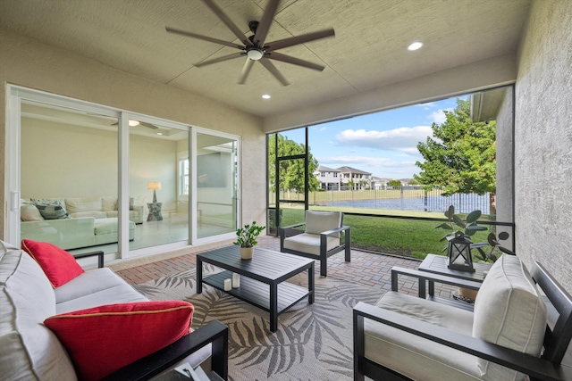 sunroom featuring ceiling fan