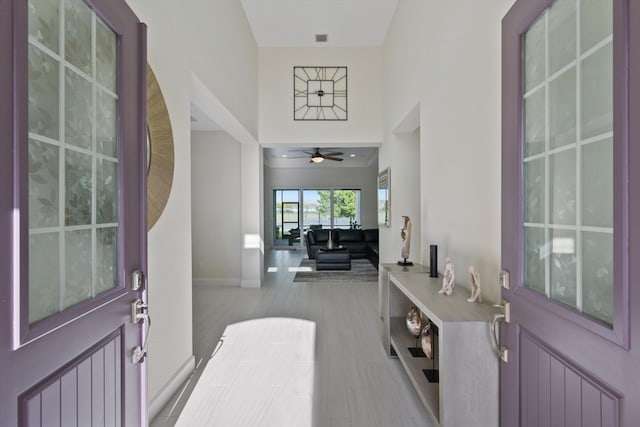 foyer with ceiling fan, radiator, and light hardwood / wood-style flooring