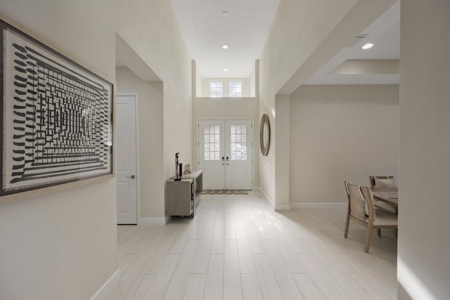 entryway with french doors and light wood-type flooring