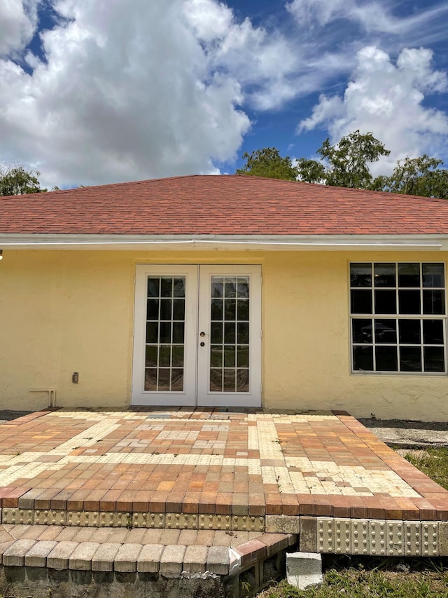 rear view of property featuring a patio area and french doors