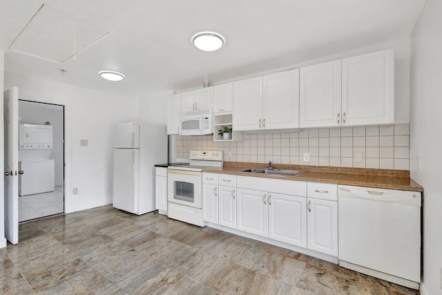 16412 62nd Rd N, The Acreage, FL 33470 - kitchen featuring white appliances, stacked washing maching and dryer, a sink, and tasteful backsplash