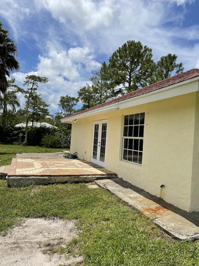 view of yard featuring a deck and french doors