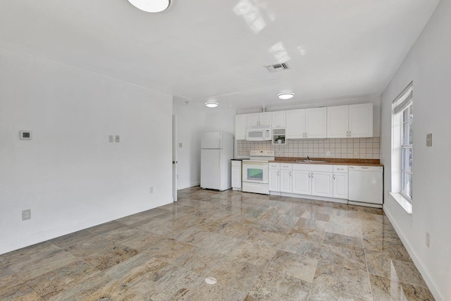 16412 62nd Rd N, The Acreage, FL 33470 - kitchen featuring white appliances, white cabinetry, visible vents, and wooden counters