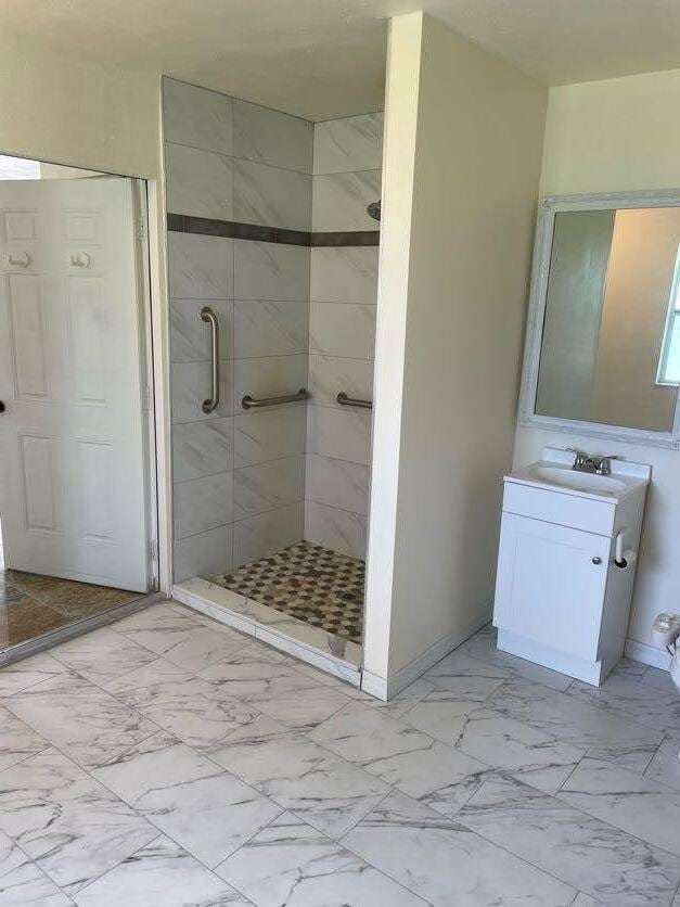 bathroom featuring vanity and an enclosed shower