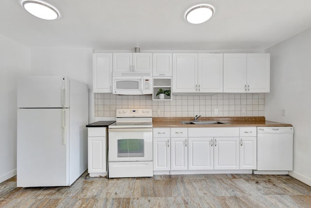 16412 62nd Rd N, The Acreage, FL 33470 - kitchen with a sink, white appliances, white cabinetry, baseboards, and backsplash